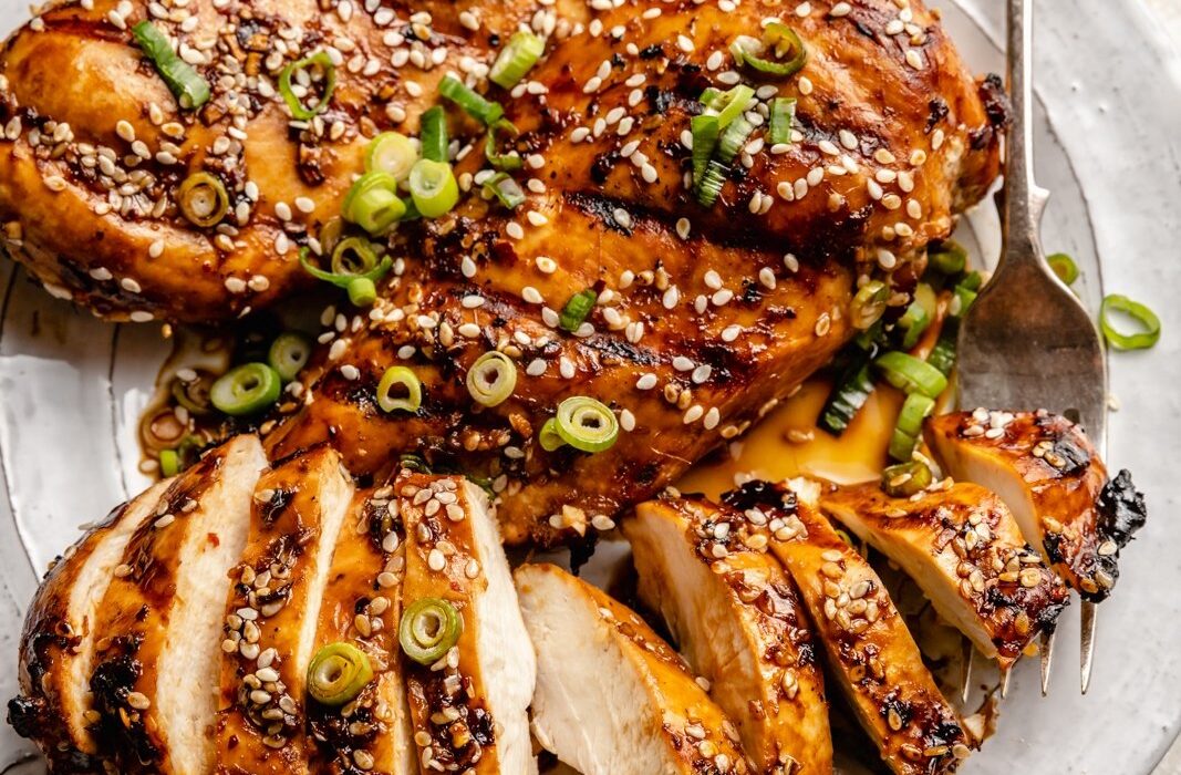 grilled sesame chicken sliced on a plate