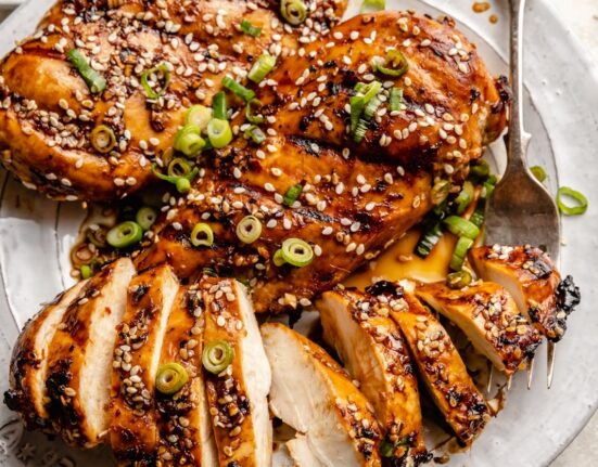 grilled sesame chicken sliced on a plate