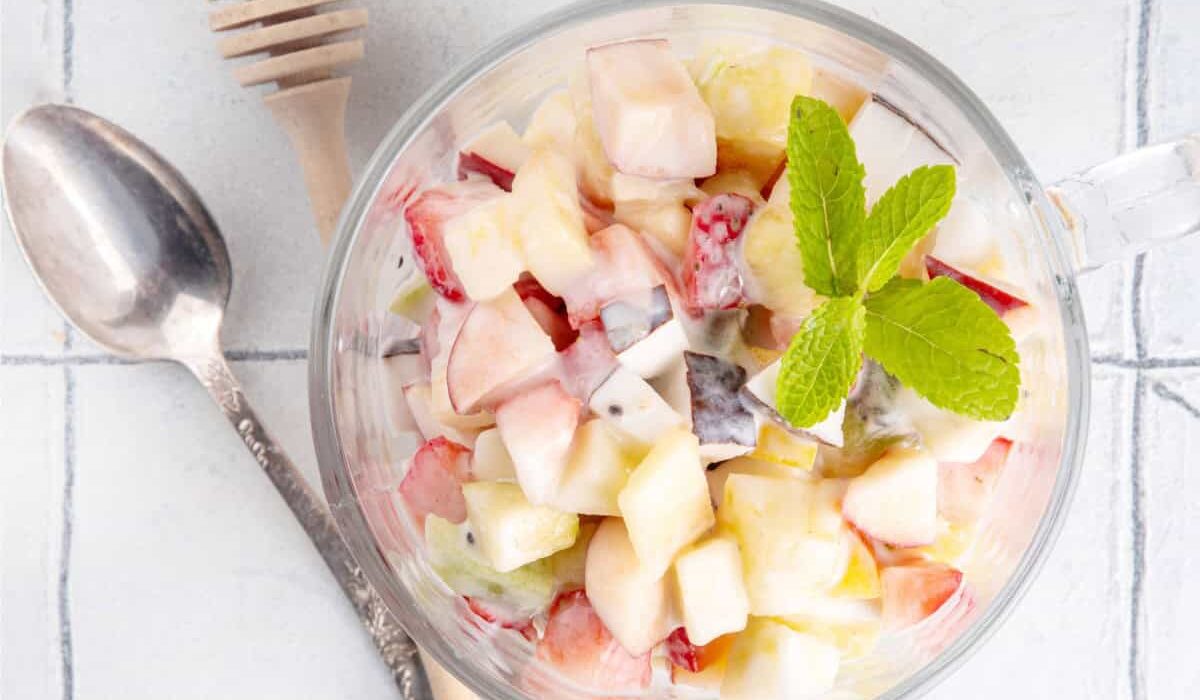 Overhead image of Cheesecake Fruit Salad in a glass mug