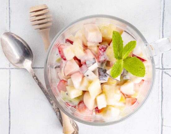 Overhead image of Cheesecake Fruit Salad in a glass mug