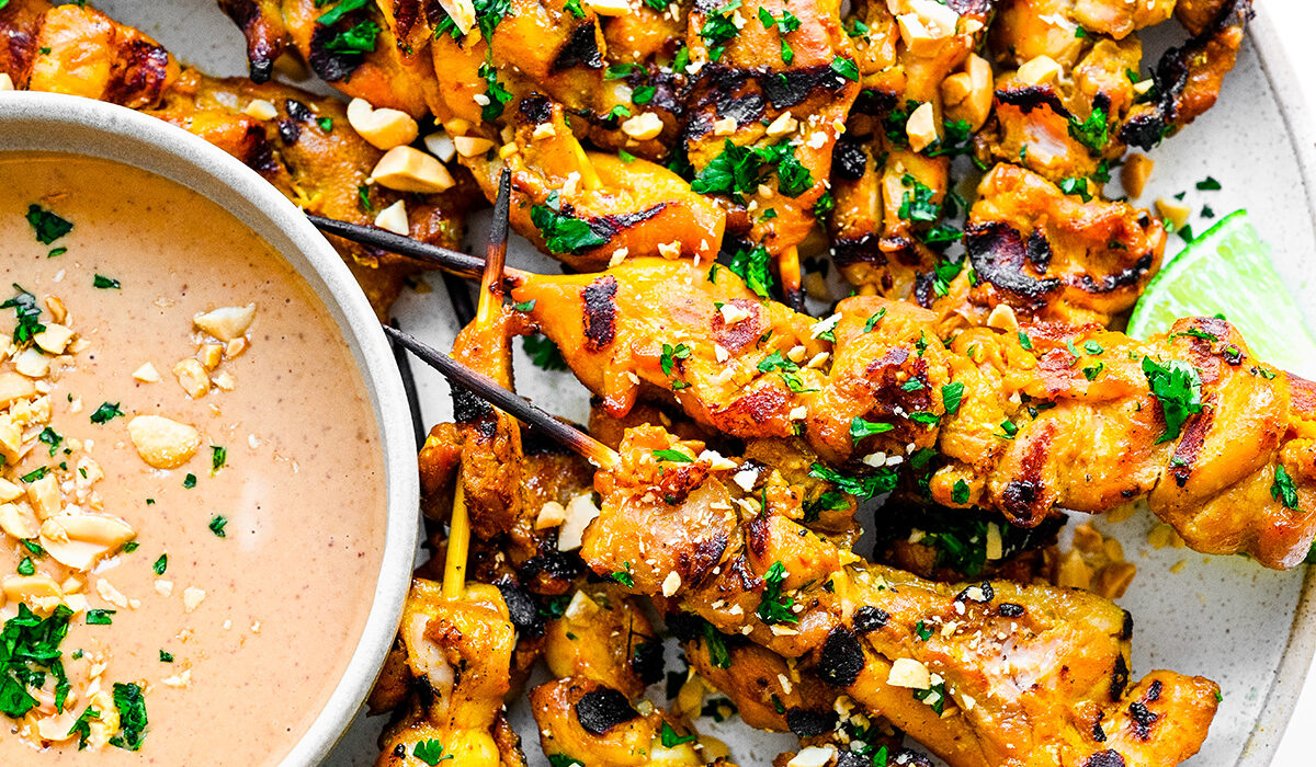 Chicken satay on a plate.