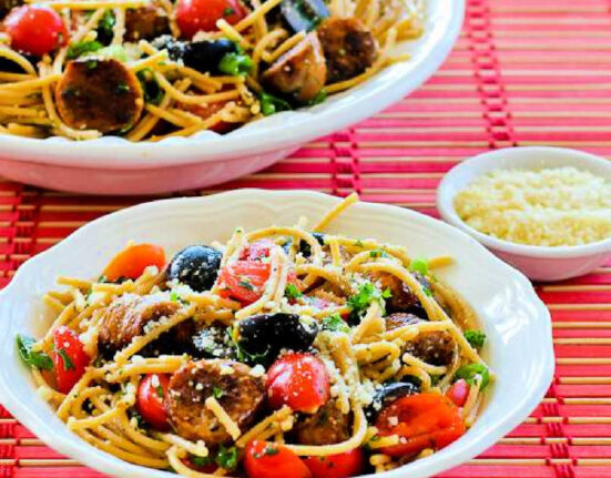 Spaghetti Pasta Salad in two serving bowls on red placemat.