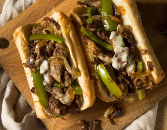 Overhead image of two Blackstone Philly Cheesesteaks on a wooden cutting board