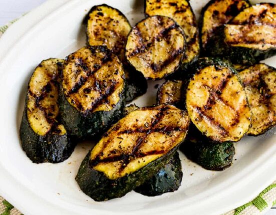 Square image for How to Grill Zucchini showing zucchini on serving plate.