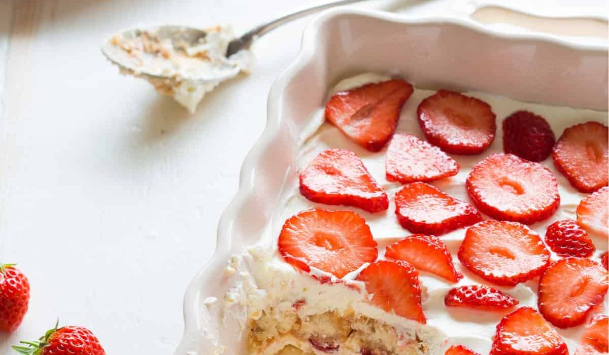 Close up image of Strawberry Tiramisu in a baking dish with a portion missing