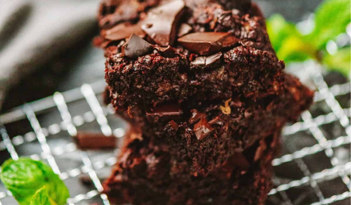A stack of zucchini brownies on a wire cooling rack
