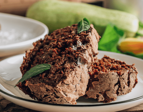 Chocolate zucchini cake on a white plate
