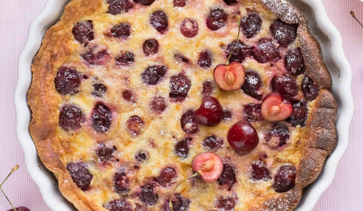 Overhead image of a Cherry Clafoutis in a white pie plate