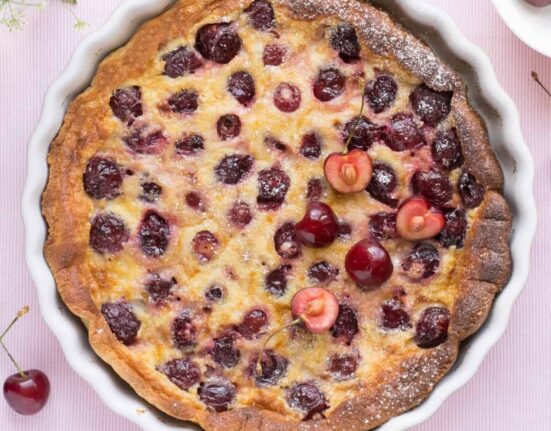 Overhead image of a Cherry Clafoutis in a white pie plate