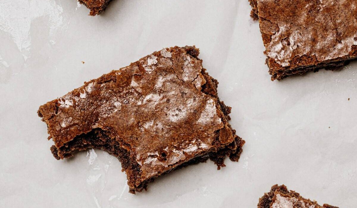 Overhead image of Lunch Lady Brownies cut into pieces on parchment paper