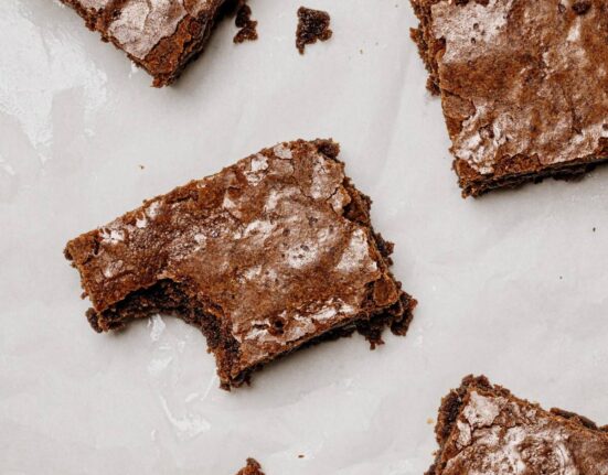 Overhead image of Lunch Lady Brownies cut into pieces on parchment paper