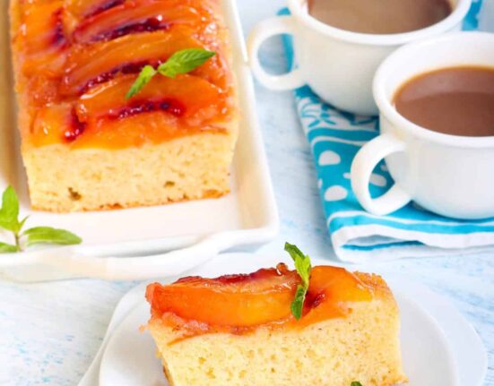 Overhead image of Peach Upside Down Cake with a slice on a plate