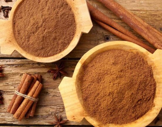 Overhead image of Apple Pie Spice in two bowls with cinnamon sticks next to them