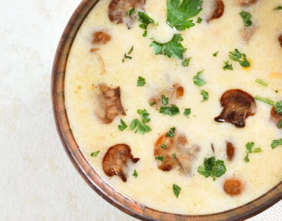 Close up image of Creamy Mushroom Soup in a brown bowl