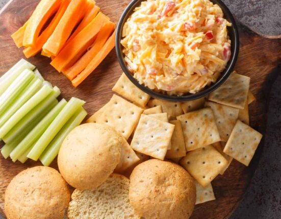 Overhead image of Pimento Cheese Dip on a board with dippers