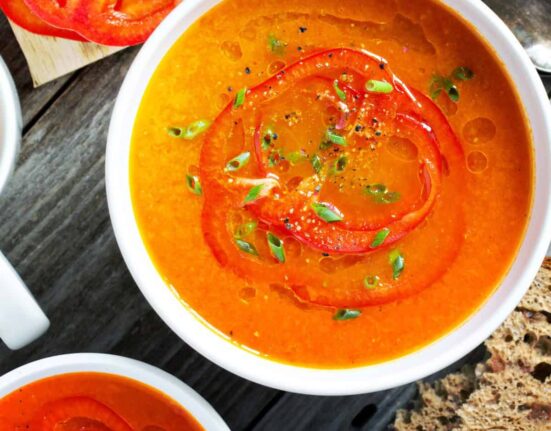 Overhead image of two bowls of Roasted Red Pepper Soup
