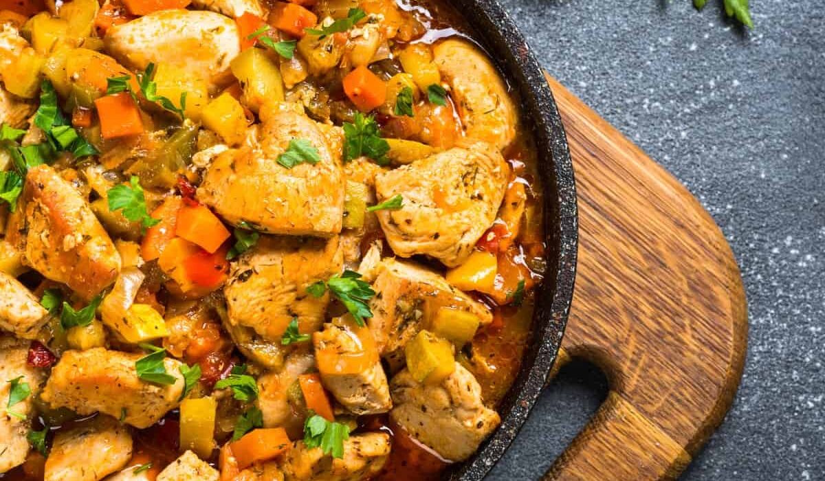 Overhead image of Slow Cooker Chicken Stew in a pan on top of a cutting board