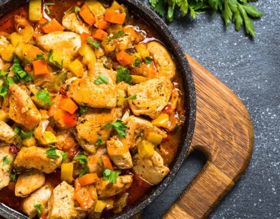 Overhead image of Slow Cooker Chicken Stew in a pan on top of a cutting board