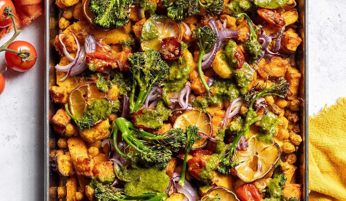Roasted vegetables and chickpeas on a baking tray.