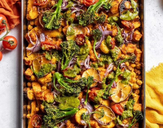 Roasted vegetables and chickpeas on a baking tray.