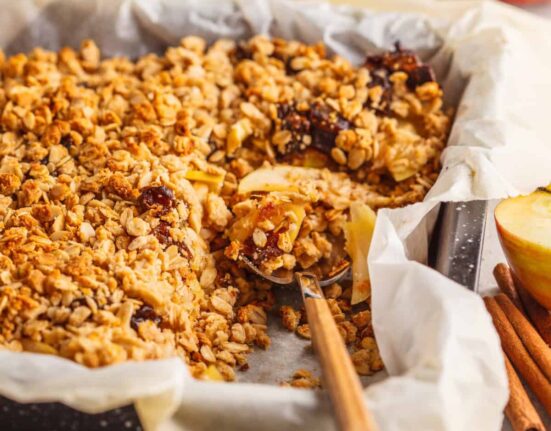 Baked Apple Cinnamon Oatmeal with a serving spoon