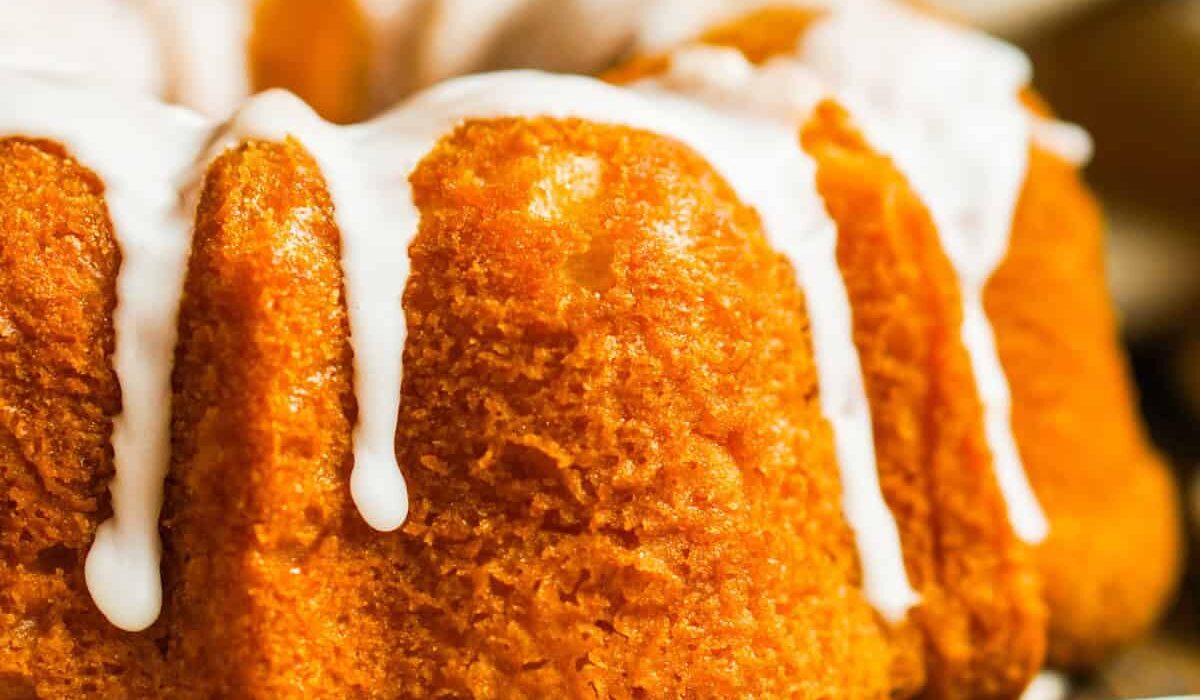 Close up image of a Pumpkin Bundt Cake with glaze drizzle