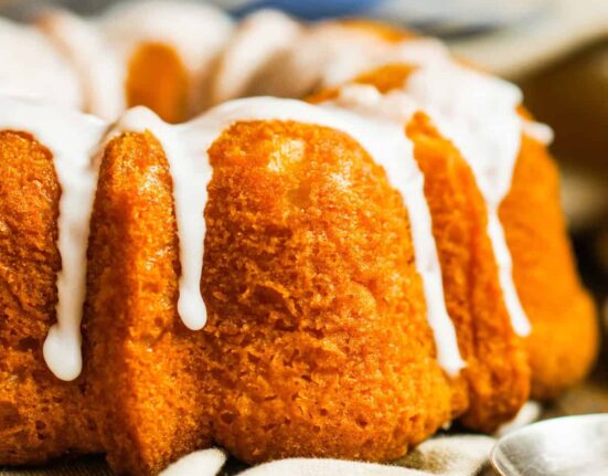 Close up image of a Pumpkin Bundt Cake with glaze drizzle