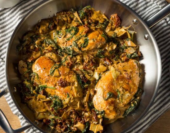 Overhead image of Spinach Artichoke Chicken in a pan