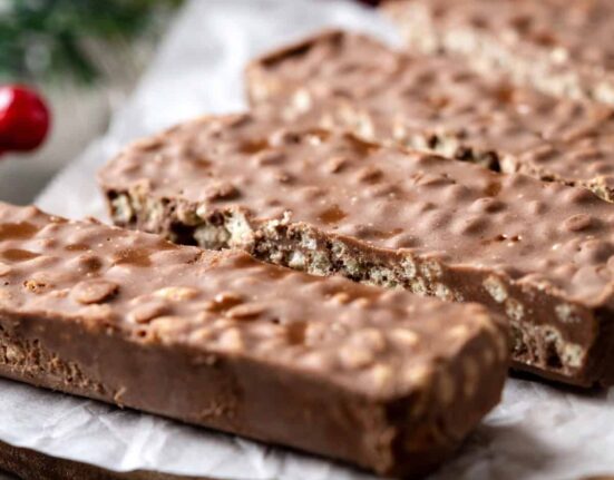 Homemade Crunch Bars on a rustic table with parchment paper