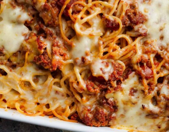 Close up image of baked spaghetti in a baking dish