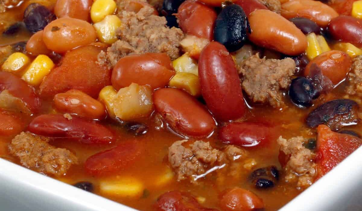 Close up image of Crockpot Taco Soup in a square white bowl