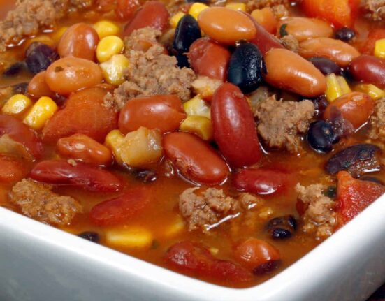 Close up image of Crockpot Taco Soup in a square white bowl
