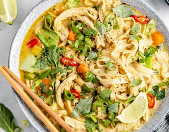 curry chicken noodle soup in a bowl with chopsticks