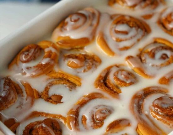 Close up image of Orange Rolls in a baking pan