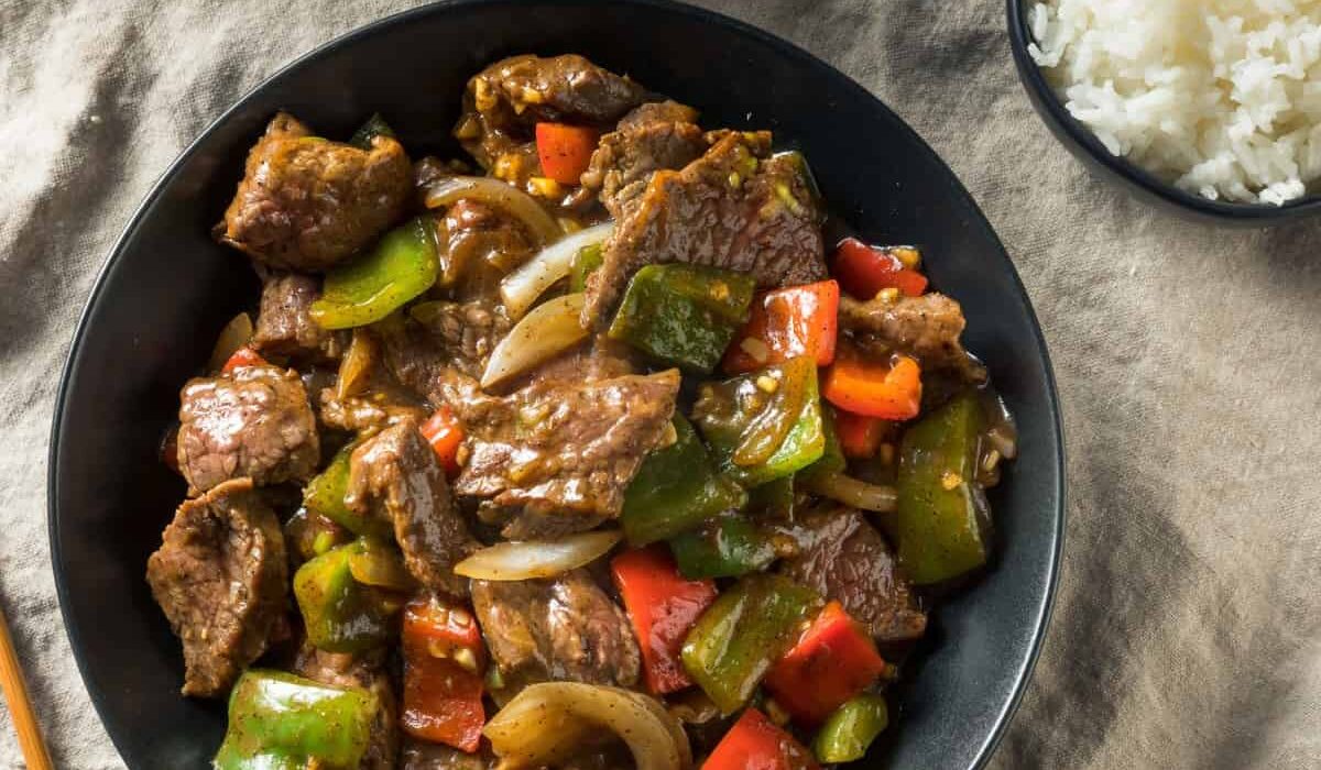 Overhead image of Pepper Steak in a bowl with rice on the side