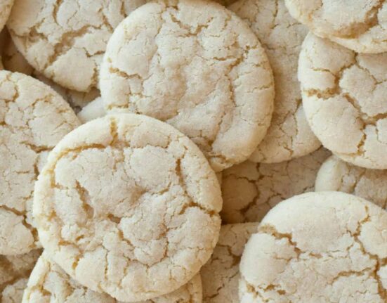 A close up image of a bunch of soft sugar cookies stacked on top of eachother