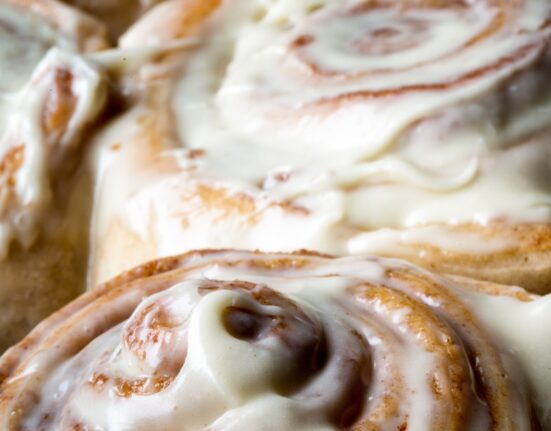close up image of frosted protein cinnamon rolls