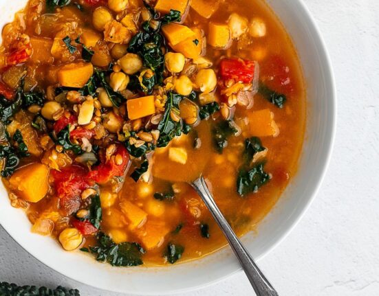 winter minstrone in a white bowl on a white surface