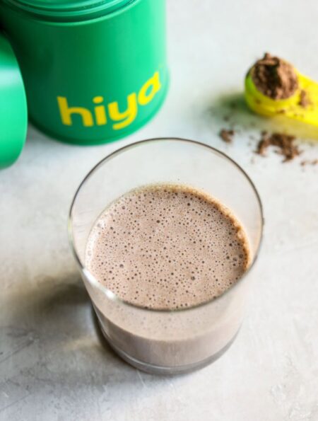 Overhead view of a glass of hiya drink mix showing the frothy chocolate top.