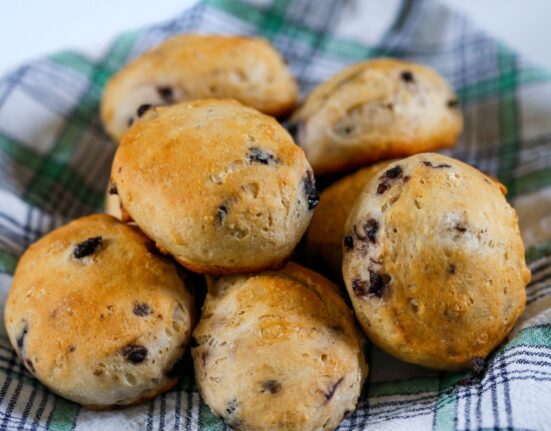 Blueberry Biscuits on a plaid cloth stacked in a pile
