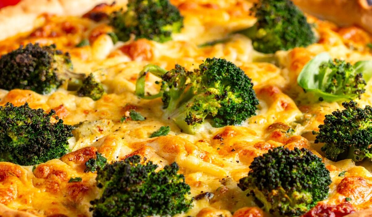 A Broccoli Quiche uncut on a white plate