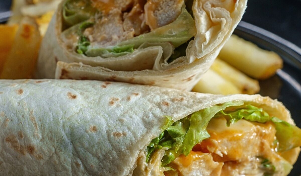 Close up image of a Buffalo Chicken Wrap cut in half
