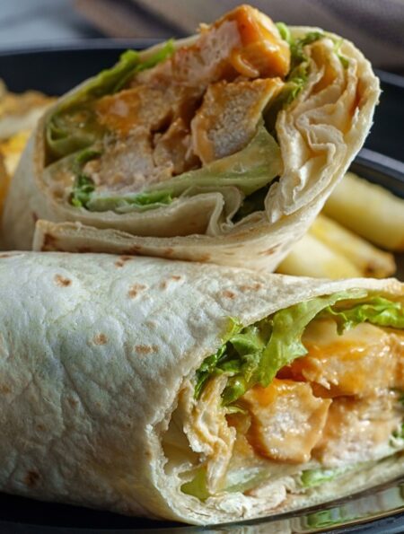 Close up image of a Buffalo Chicken Wrap cut in half
