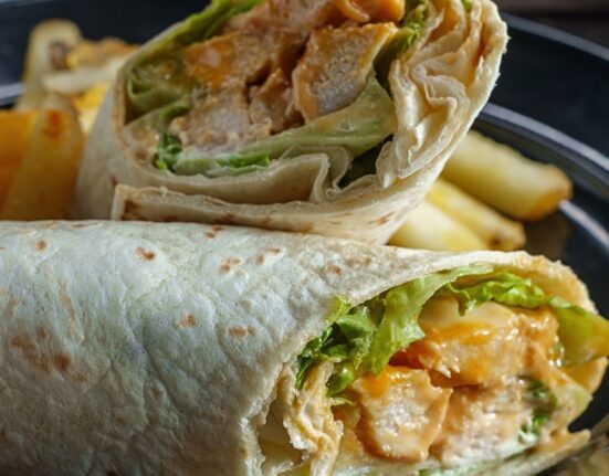 Close up image of a Buffalo Chicken Wrap cut in half
