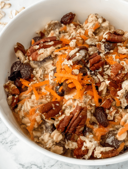 close-up view of carrot cake overnight oats in a white bowl