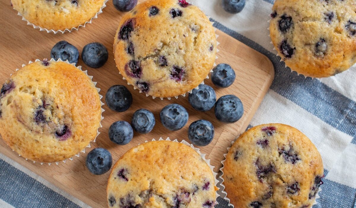 Overhead image of cottage cheese muffins with blueberries ona cutting board