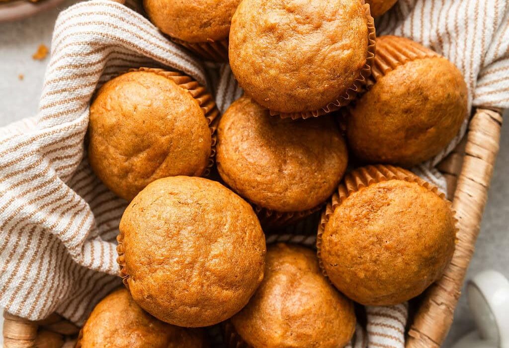Overhead view of a basket filled with freshly baked Sweet Potato Muffins..