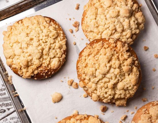 Baked Vegan Streuselbrötchen (crumble rolls) on a baking tray.