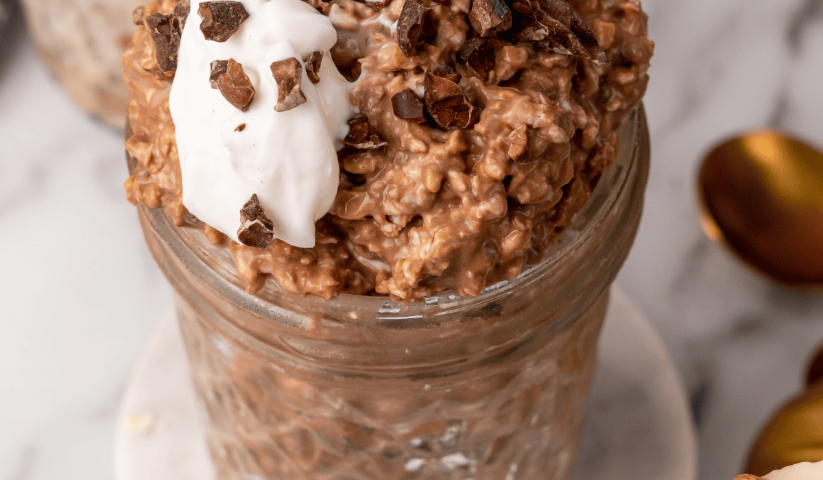 Healthy chocolate overnight oats with yogurt, protein, and fiber in a glass jar. Perfect for quick,.