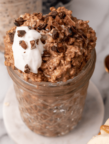 Healthy chocolate overnight oats with yogurt, protein, and fiber in a glass jar. Perfect for quick,.